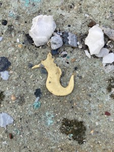 Seahorse art made by blob of caulk on ground