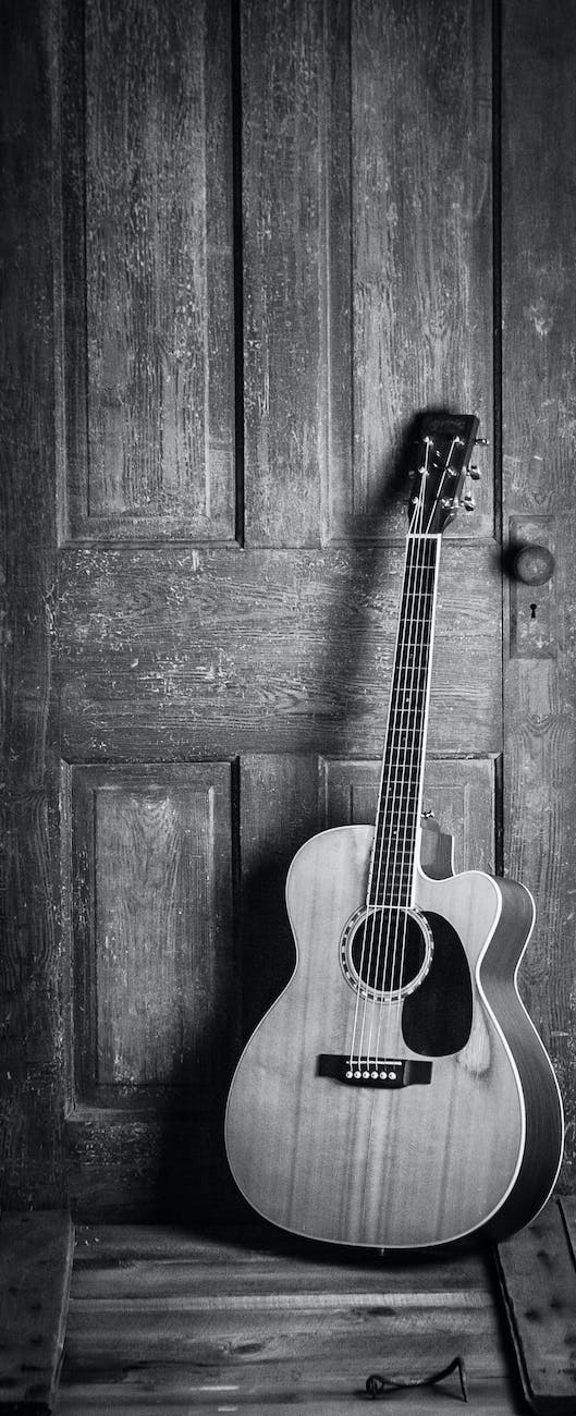 Acoustic guitar looks old, vintage against wood