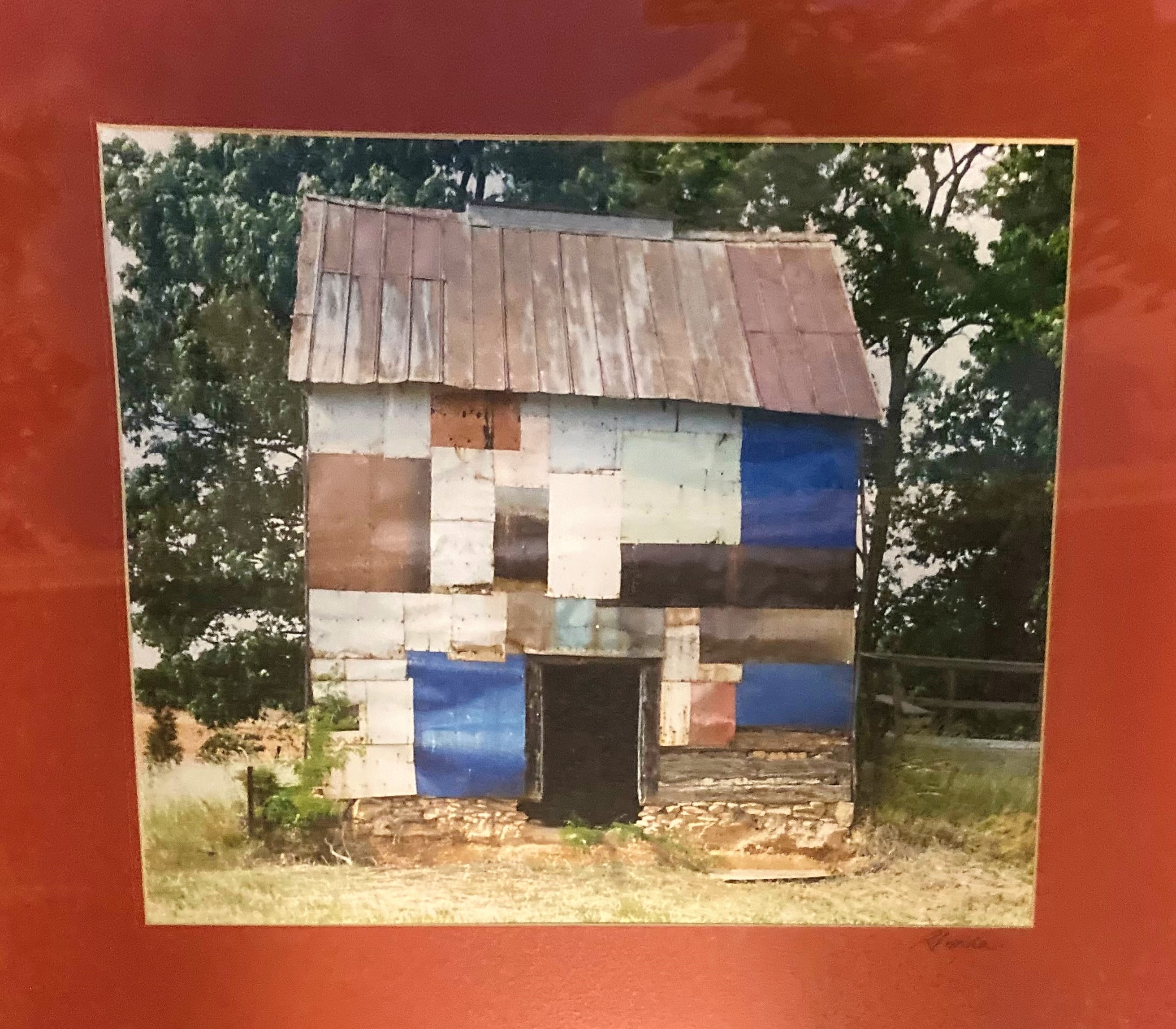 Tobacco barn with tin roof and colorful patches on walls